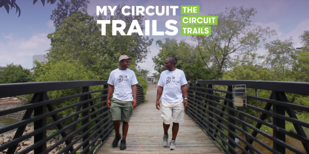 father and son walking along a pedestrian bridge on the Chester Riverfront Trail